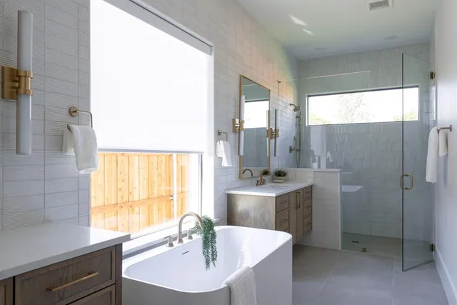 a bathroom with a tub sink and mirror