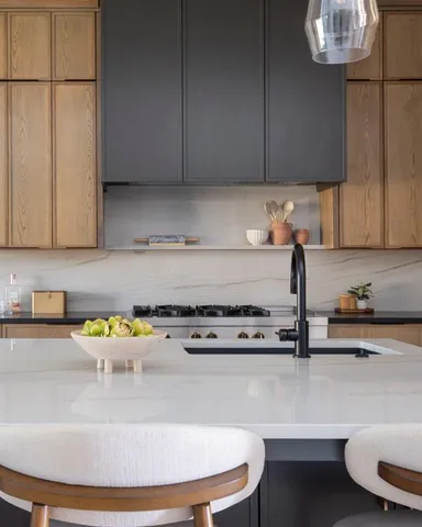 a kitchen with a stove and a white wooden cabinets