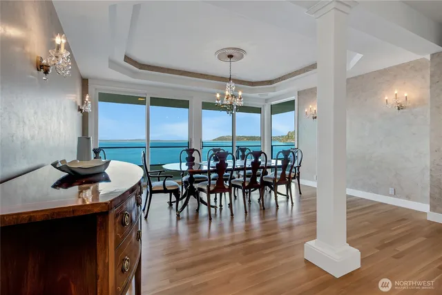 a living room with furniture a dining table and a large window
