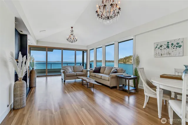 a living room with furniture fireplace and a large window