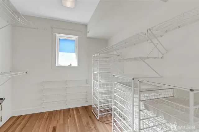 a bathroom with a sink and a large mirror next to a window