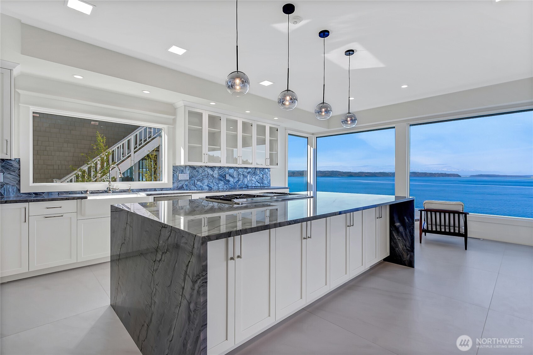 16331 Maplewild Avenue Southwest Burien, WA 98166 - Photo 3 of 31 a large kitchen with kitchen island a large counter space a sink a center island and stainless steel appliances
