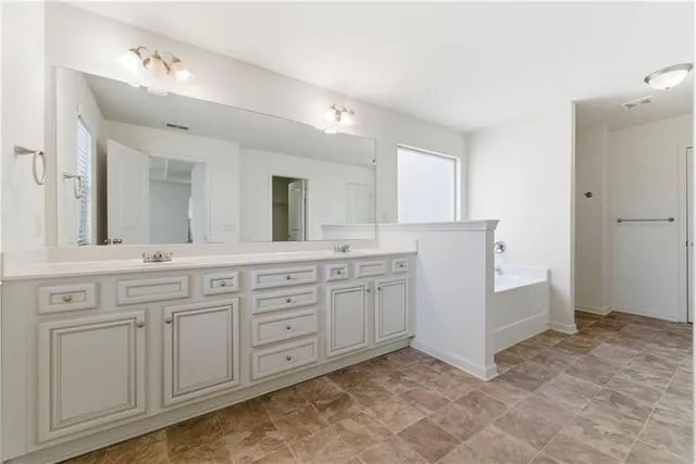a view of a bathroom with a bathtub and shower