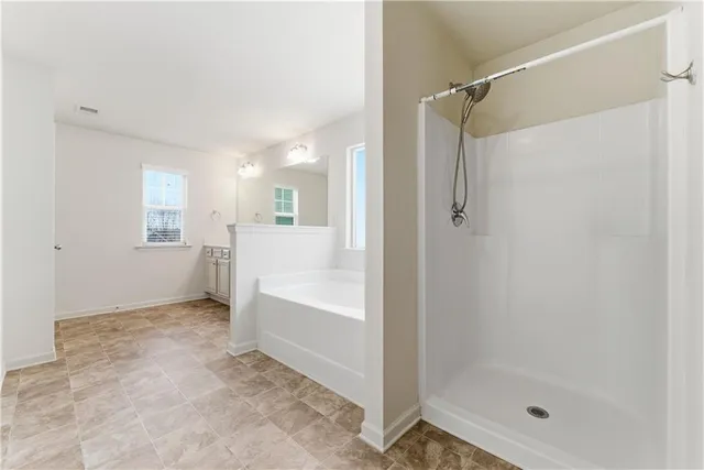 a bathroom with a tub sink and a window