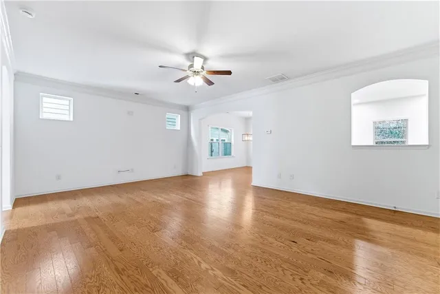 a view of kitchen view wooden floor cabinets and stainless steel appliances