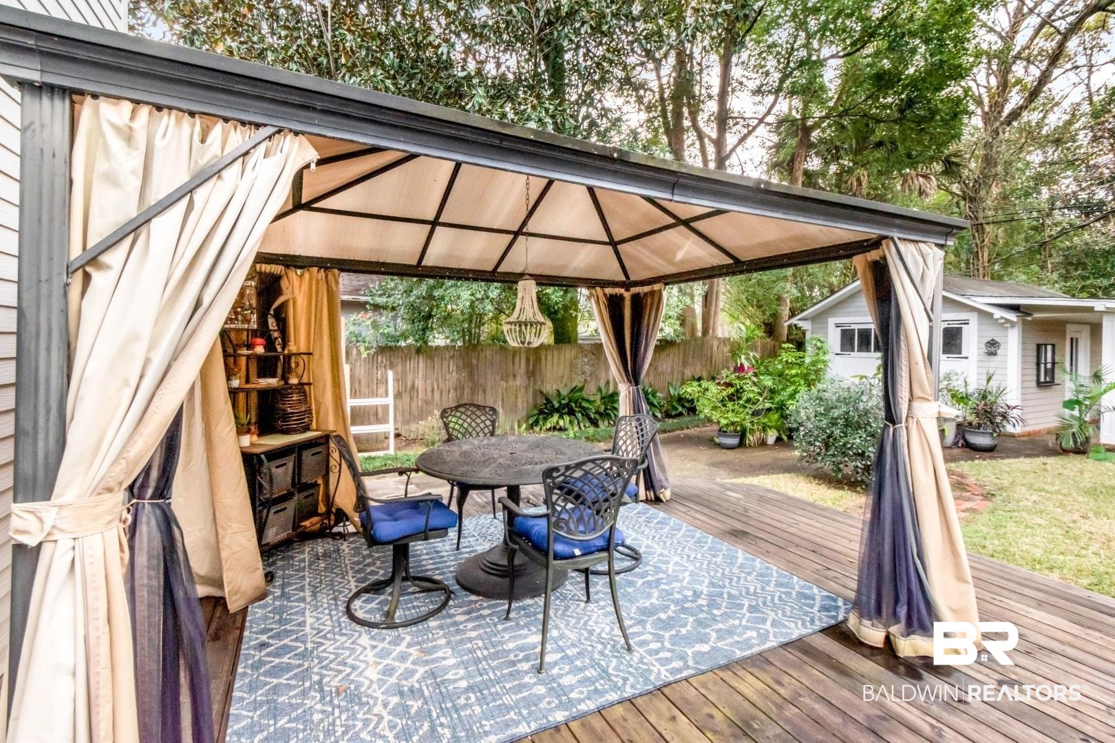 135 Silverwood Street Mobile, AL 36607 - Photo 22 of 32 Deck featuring a gazebo, outdoor dining space, and an outdoor structure