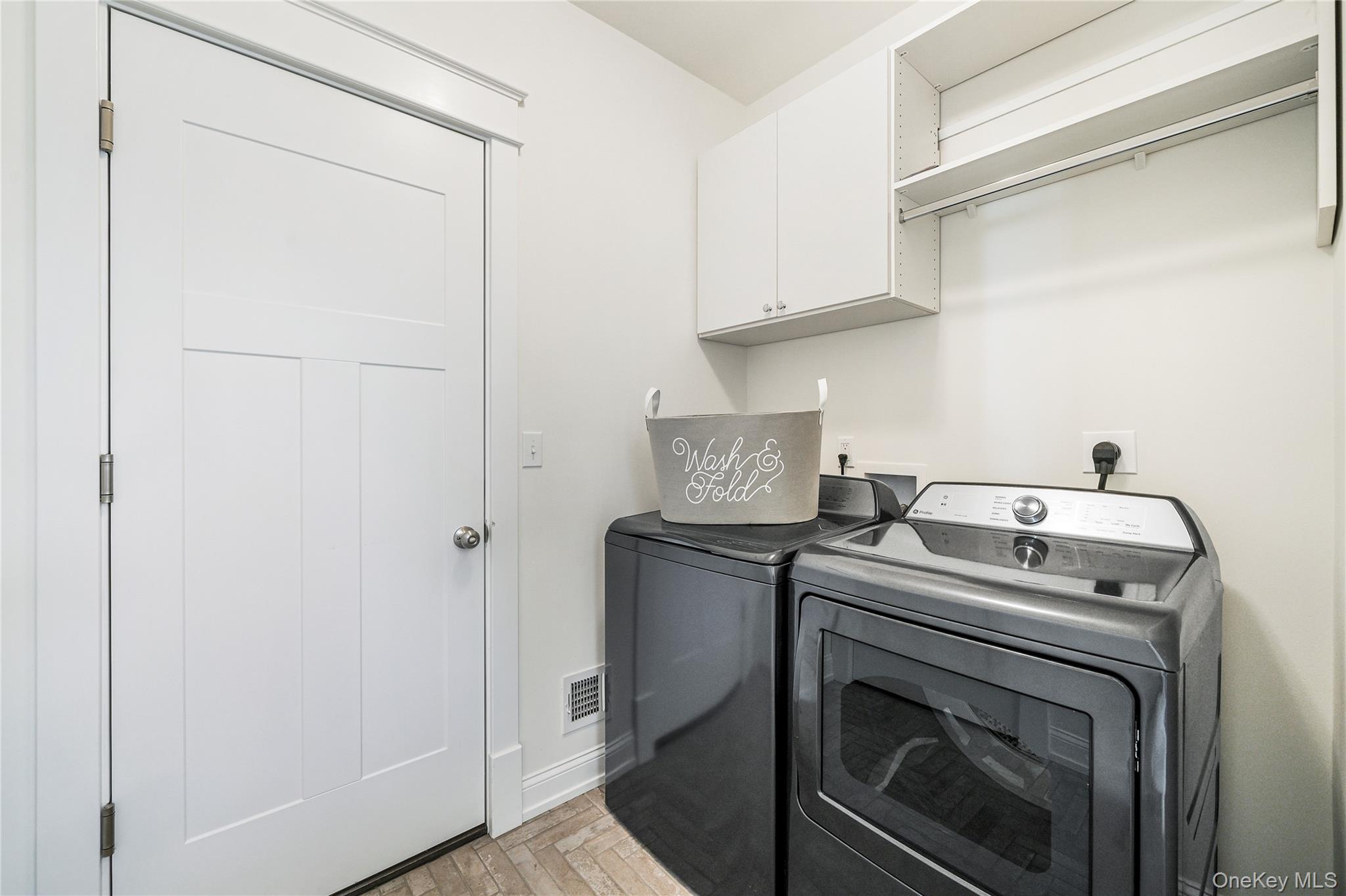 2040 Crompond Road, Unit 17 Yorktown Heights, NY 10598 - Photo 21 of 22 Clothes washing area featuring separate washer and dryer and cabinets