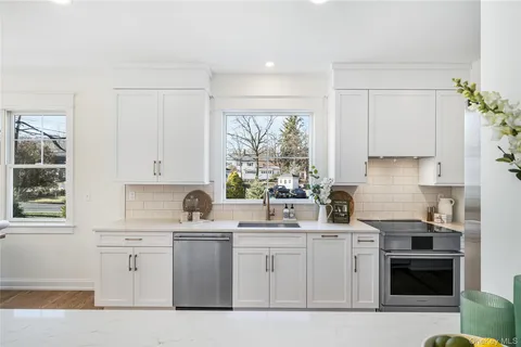 a kitchen with white cabinets and white appliances