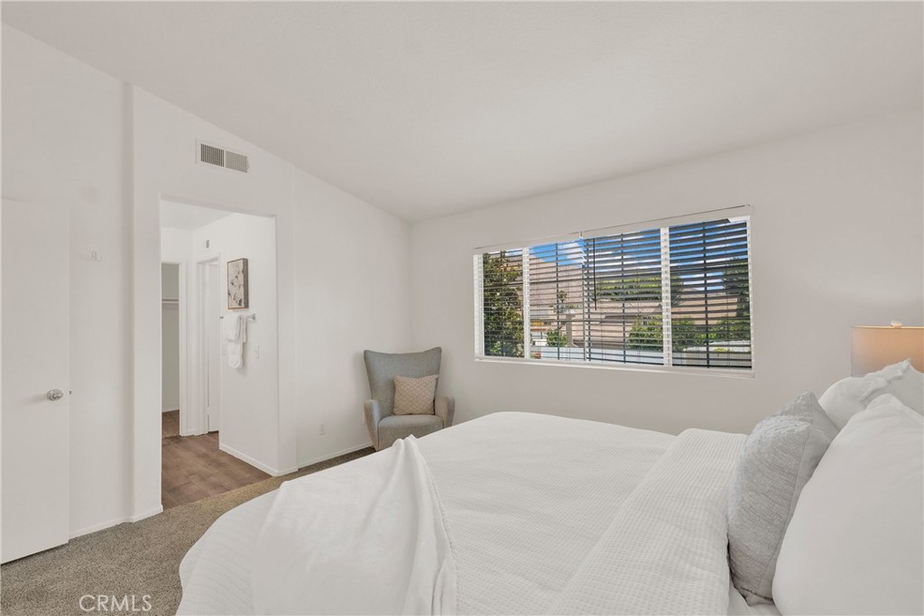 5895 Applecross Drive Riverside, CA 92507 - Photo 19 of 35 a bedroom with a bed and a window with chair
