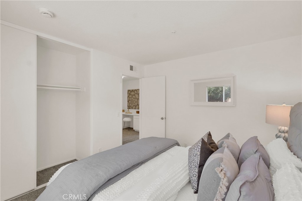 5895 Applecross Drive Riverside, CA 92507 - Photo 25 of 35 a bedroom with a bed and a lamp