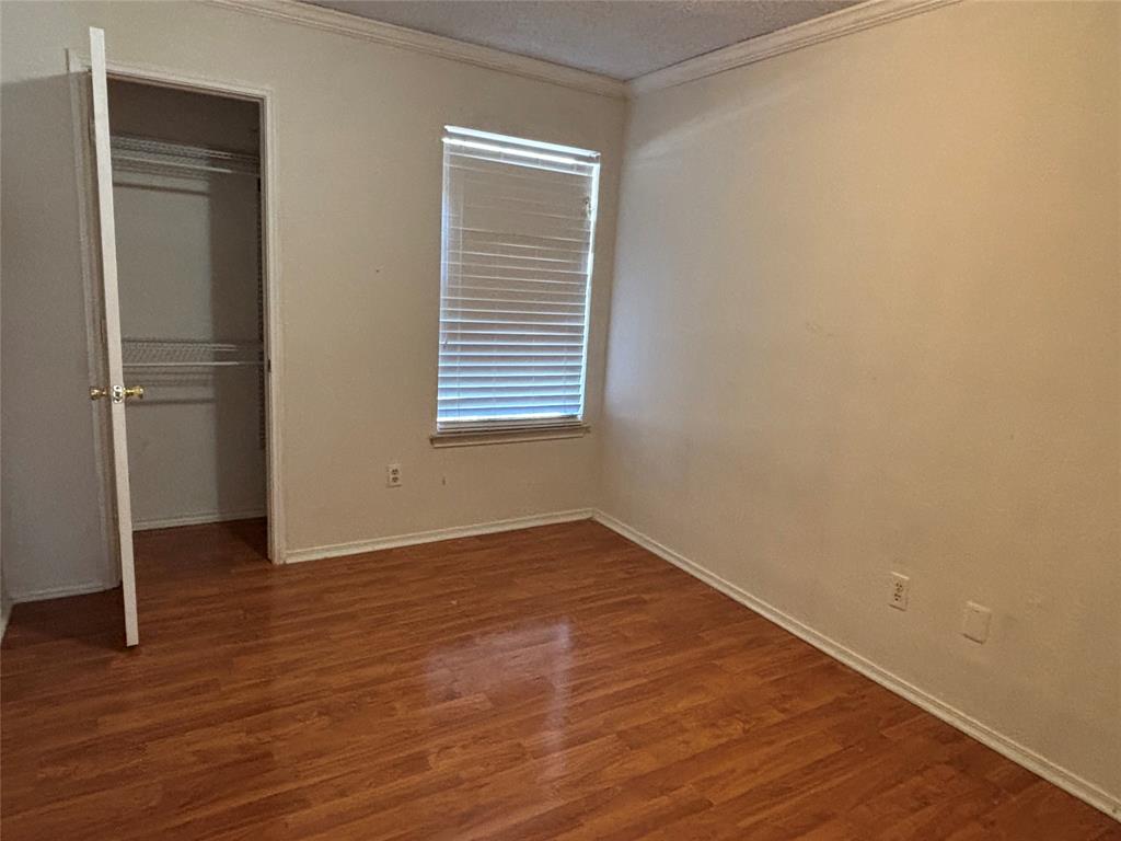 2313 Foot Hill Road McKinney, TX 75072 - Photo 6 of 13 a view of an empty room with wooden floor and a window