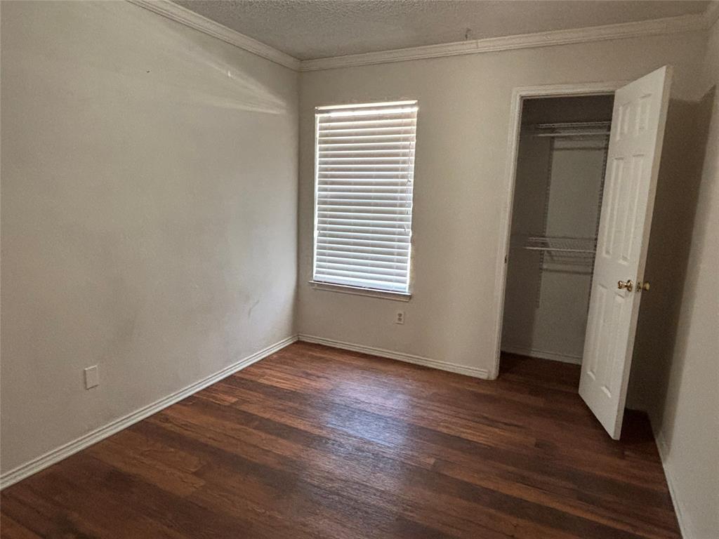 2313 Foot Hill Road McKinney, TX 75072 - Photo 7 of 13 an empty room with wooden floor and a window