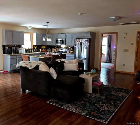 a living room with lots of furniture and kitchen view