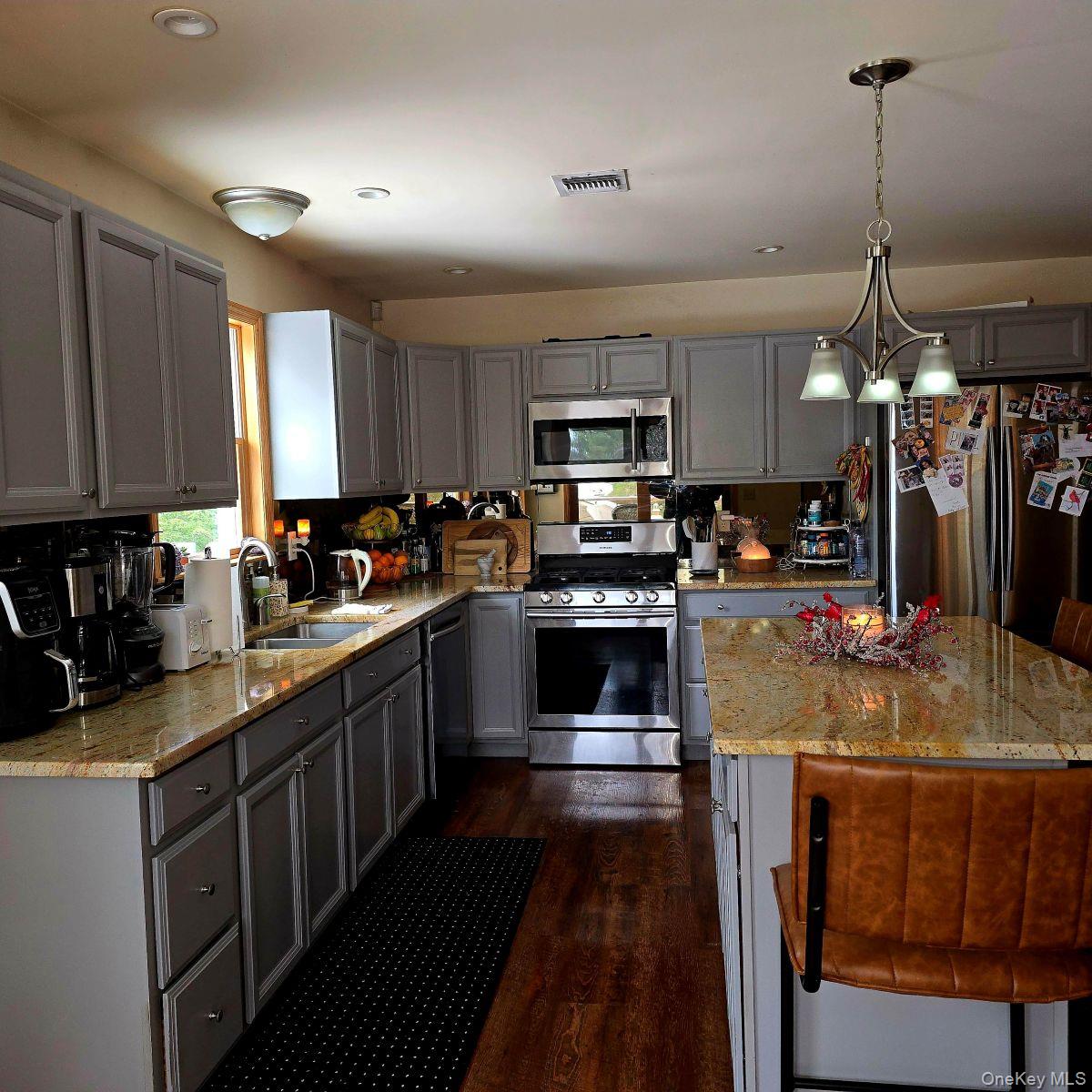 85 Swinging Bridge Estate Road Monticello, NY 12701 - Photo 4 of 12 a kitchen with kitchen island granite countertop a sink cabinets and stainless steel appliances