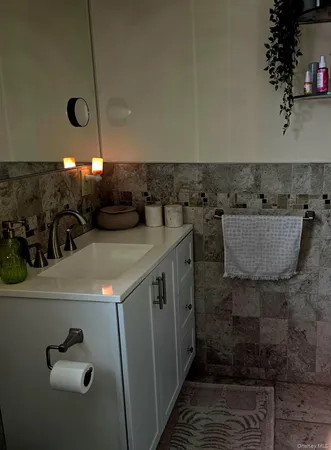 a bathroom with a sink a mirror and shower
