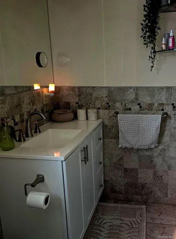 a bathroom with a sink a mirror and shower