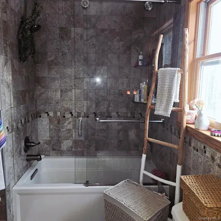 a bathroom with a tub and a window