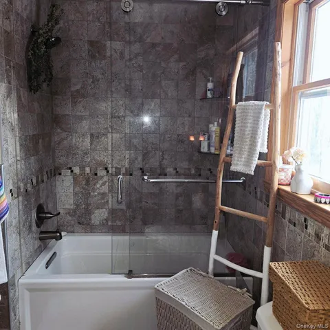 a bathroom with a tub and a window