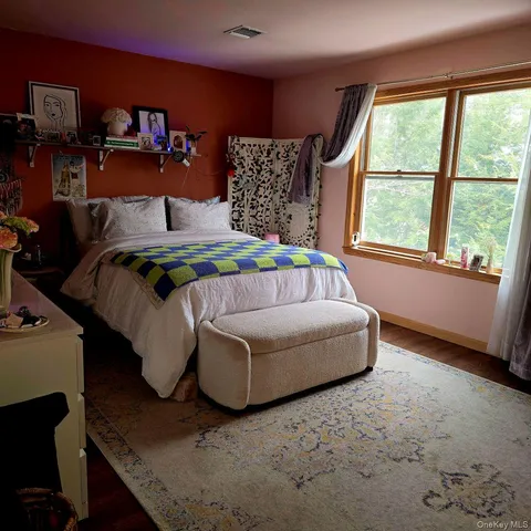 a bedroom with a bed and window