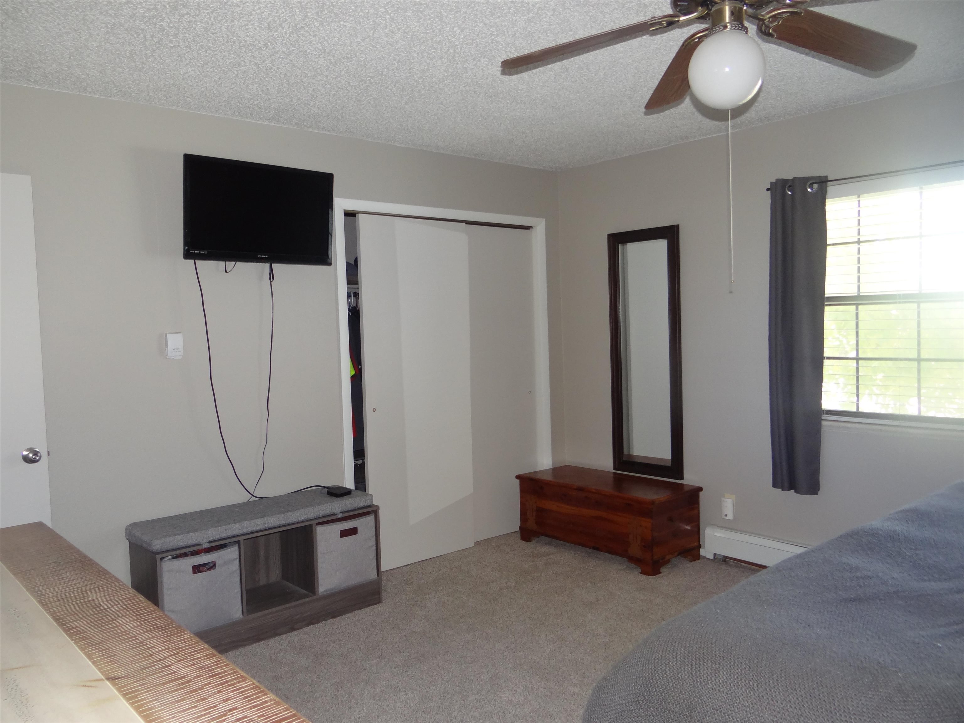 2721 Patterson Road, Unit 904 Grand Junction, CO 81506 - Photo 13 of 23 a living room with gym equipment and a flat screen tv