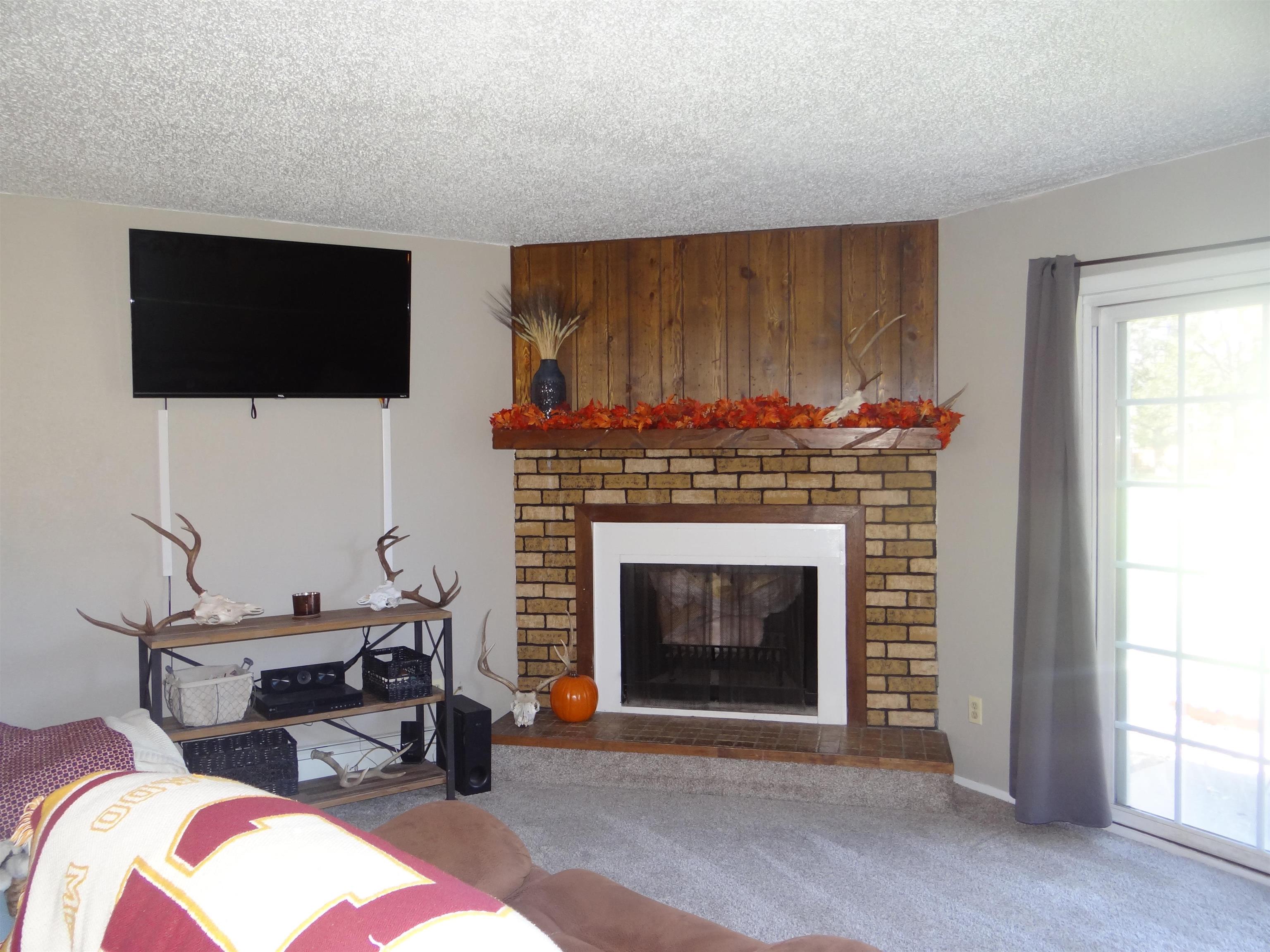 2721 Patterson Road, Unit 904 Grand Junction, CO 81506 - Photo 3 of 23 a living room with furniture a flat screen tv and a fireplace