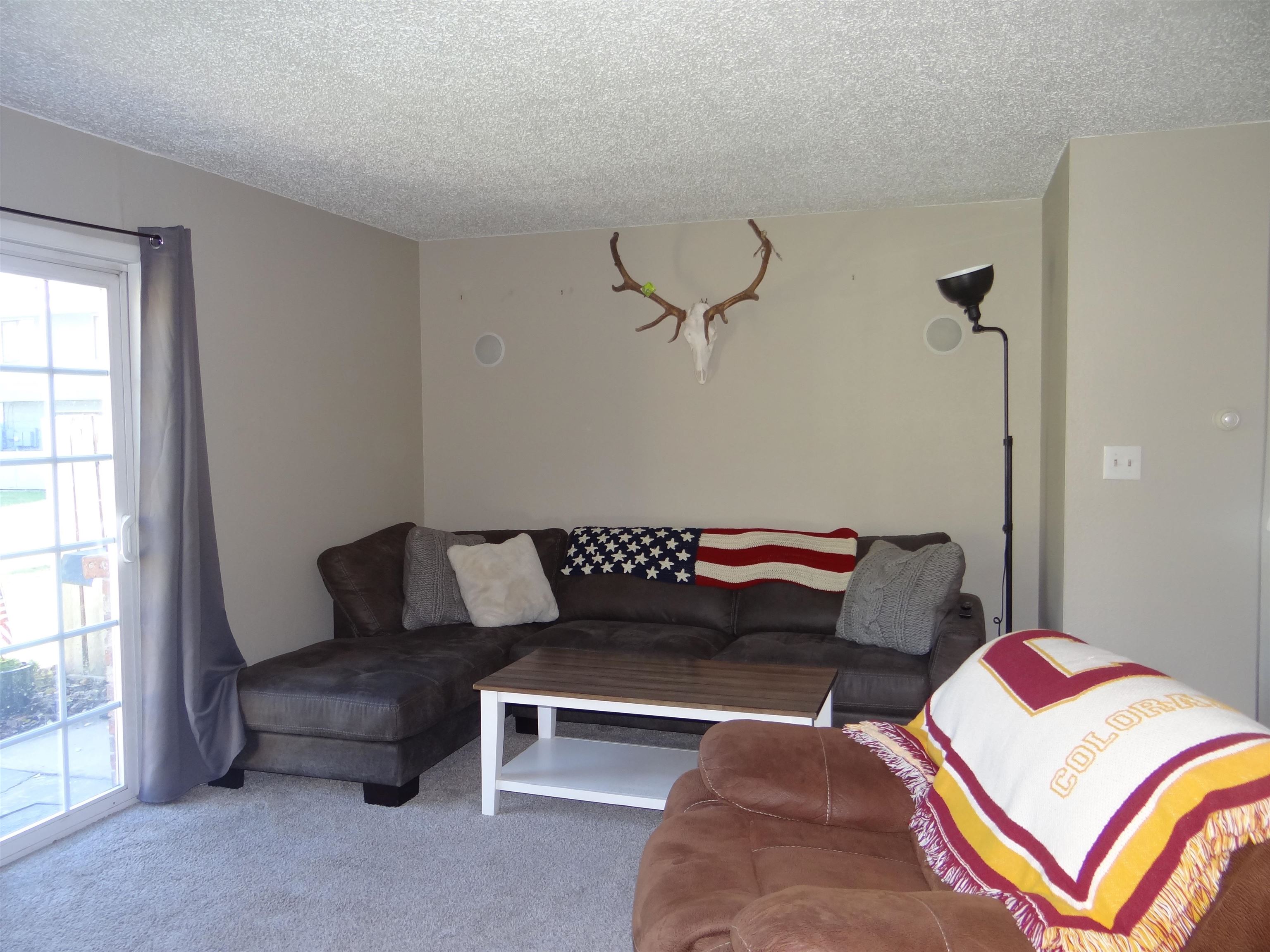 2721 Patterson Road, Unit 904 Grand Junction, CO 81506 - Photo 4 of 23 a bedroom with a bed and wooden floor