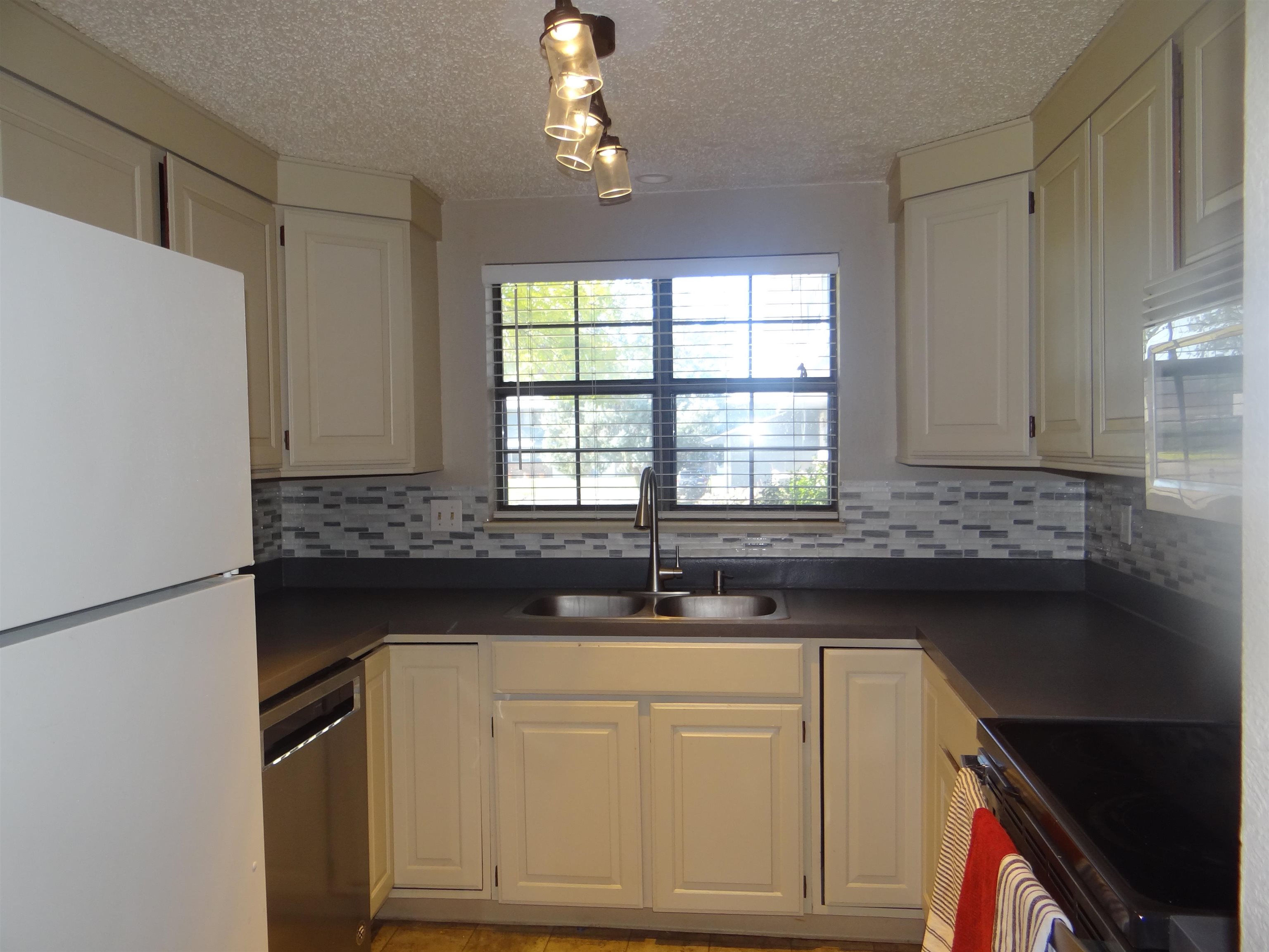 2721 Patterson Road, Unit 904 Grand Junction, CO 81506 - Photo 9 of 23 a kitchen with granite countertop a sink and cabinets