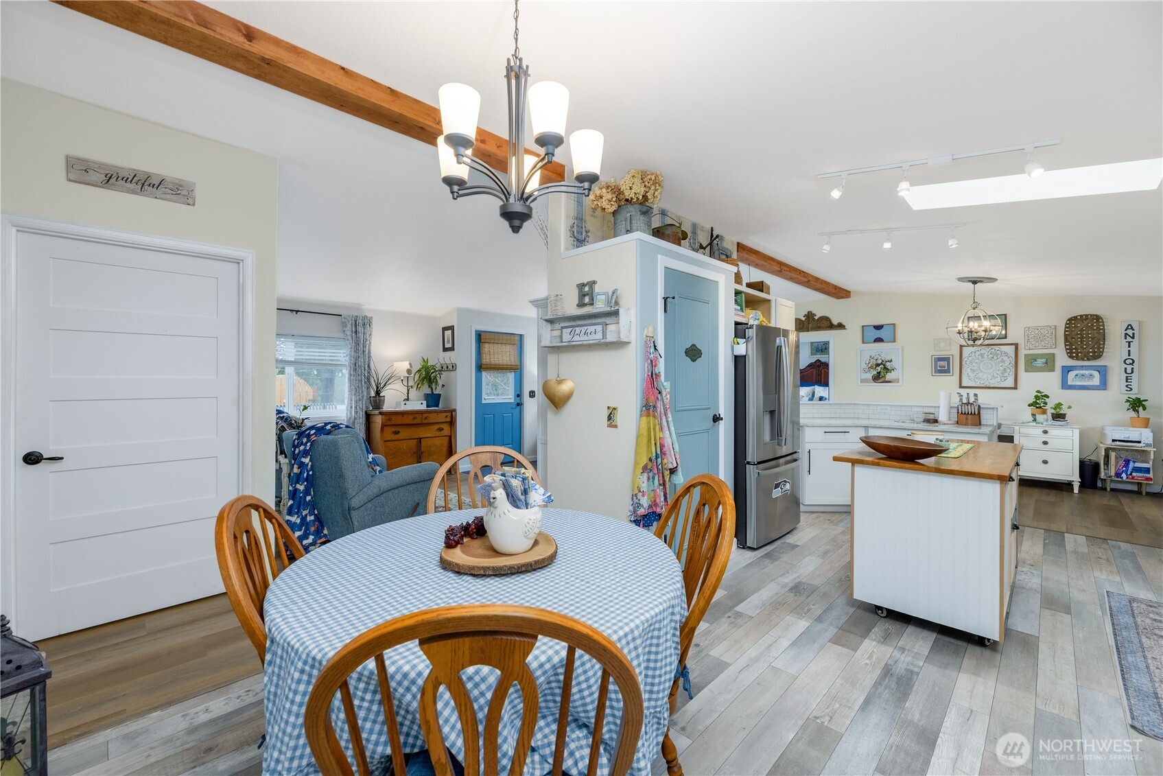1238 West 11th Street Port Angeles, WA 98363 - Photo 11 of 26 a view of a dining room with furniture a chandelier and wooden floor