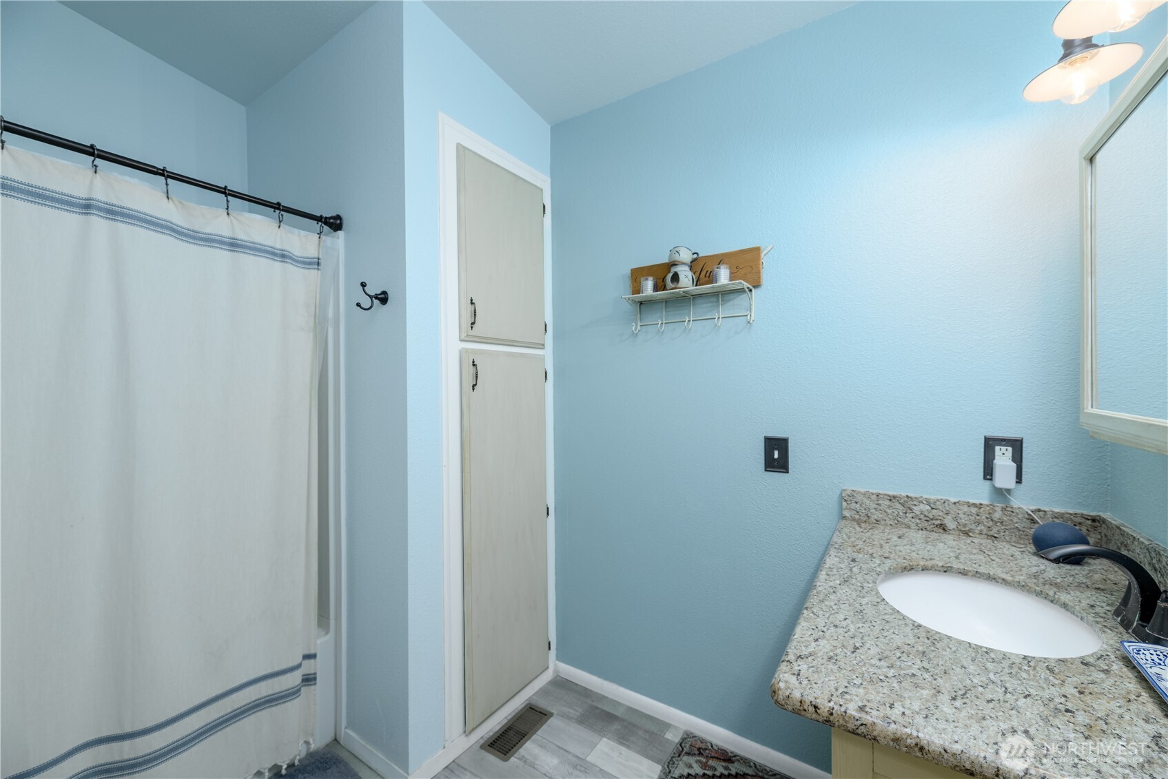 1238 West 11th Street Port Angeles, WA 98363 - Photo 22 of 26 a bathroom with a granite countertop sink and a mirror