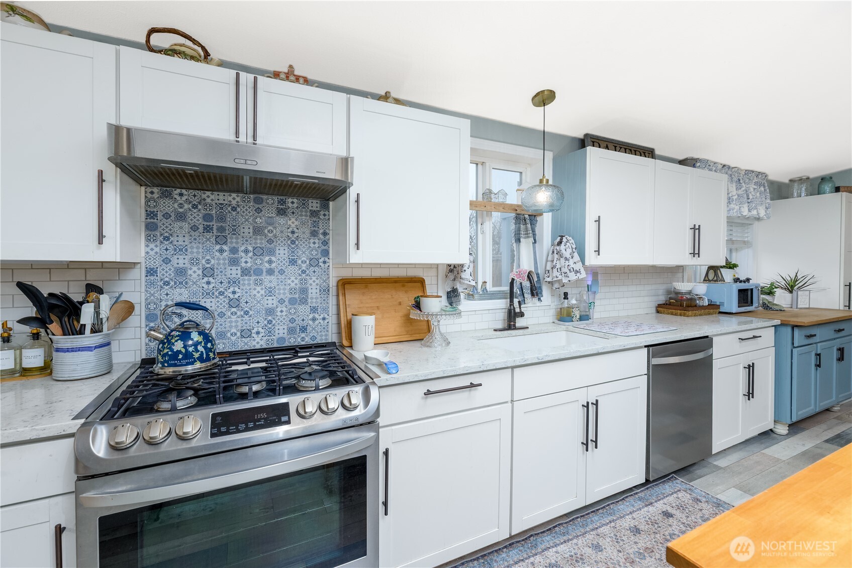 1238 West 11th Street Port Angeles, WA 98363 - Photo 9 of 26 a kitchen with white cabinets and appliances
