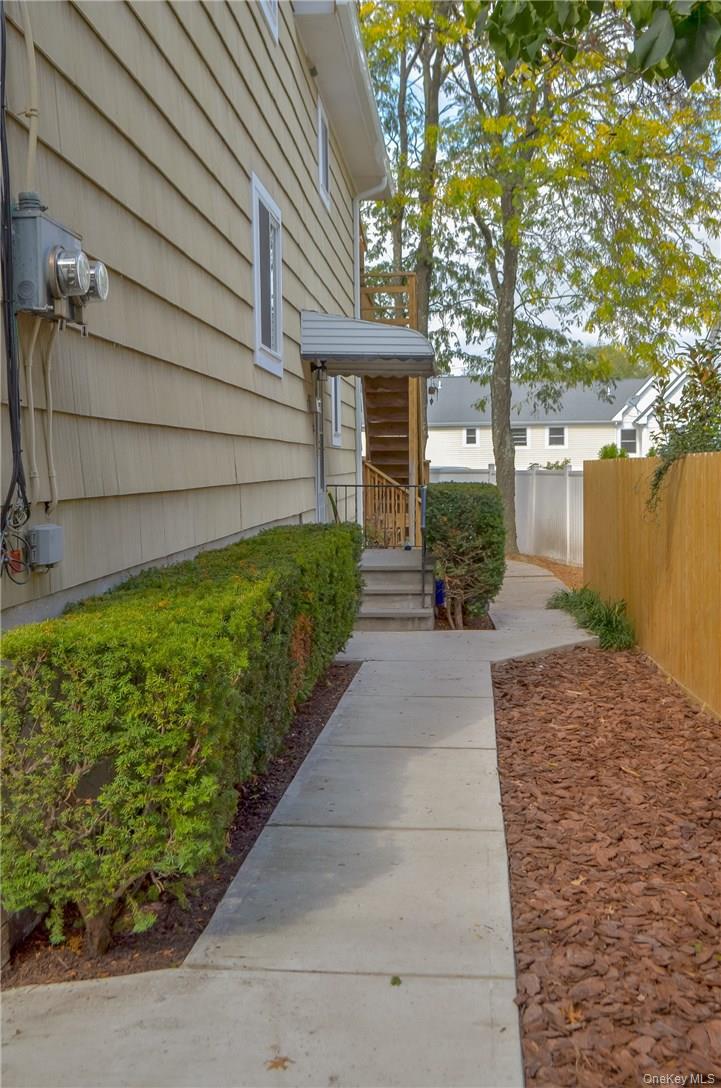 11 Elm Street, Unit 2 Sleepy Hollow, NY 10591 - Photo 17 of 33 a front view of a house with a yard and fountain