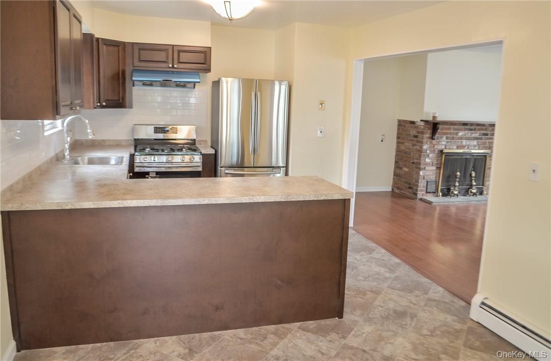 11 Elm Street, Unit 2 Sleepy Hollow, NY 10591 - Photo 3 of 33 a kitchen with stainless steel appliances a refrigerator and a stove