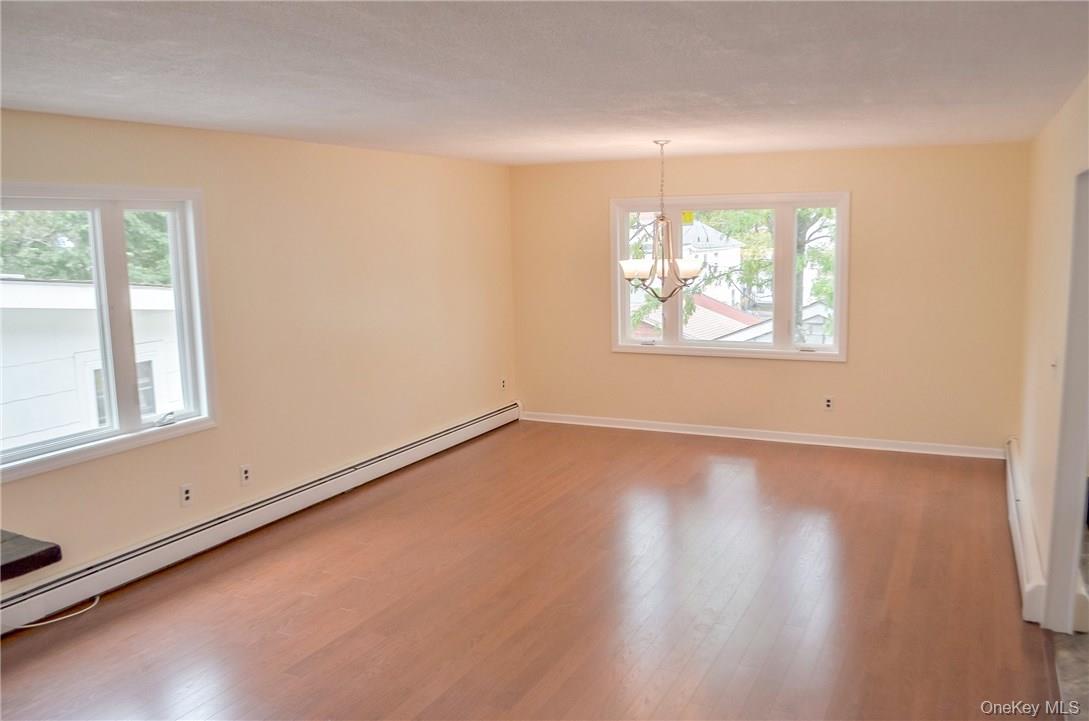 11 Elm Street, Unit 2 Sleepy Hollow, NY 10591 - Photo 5 of 33 an empty room with wooden floor and windows