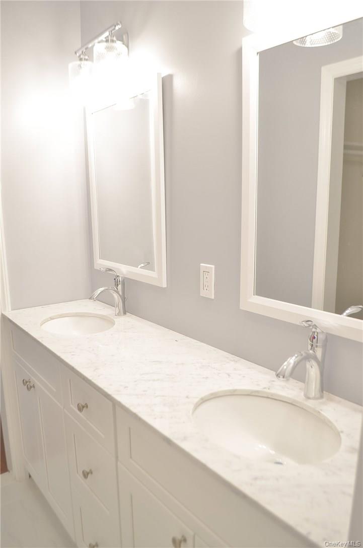 11 Elm Street, Unit 2 Sleepy Hollow, NY 10591 - Photo 6 of 33 a bathroom with a granite countertop sink and a mirror