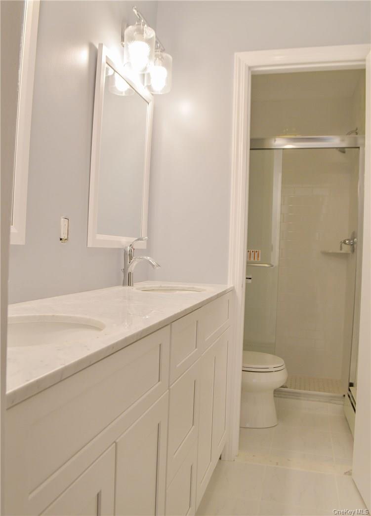 11 Elm Street, Unit 2 Sleepy Hollow, NY 10591 - Photo 7 of 33 a bathroom with a granite countertop sink a toilet and a mirror