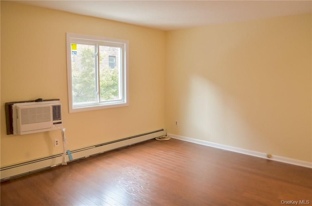 11 Elm Street, Unit 2 Sleepy Hollow, NY 10591 - Photo 9 of 33 an empty room with wooden floor and windows