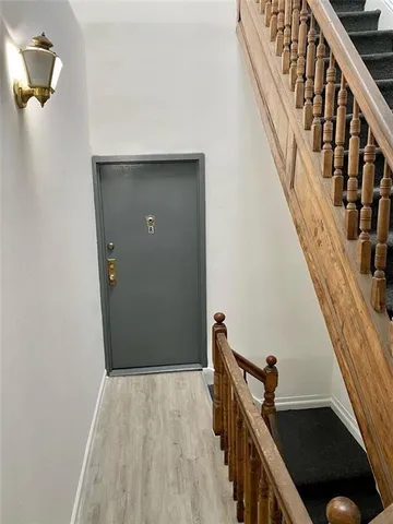 a view of an entryway with wooden floor