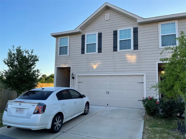 a car parked in front of white house