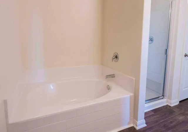 a en suite bathroom with a sink a toilet a mirror and shower