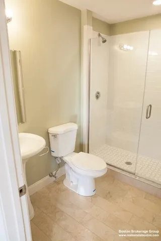 a bathroom with a toilet and a shower