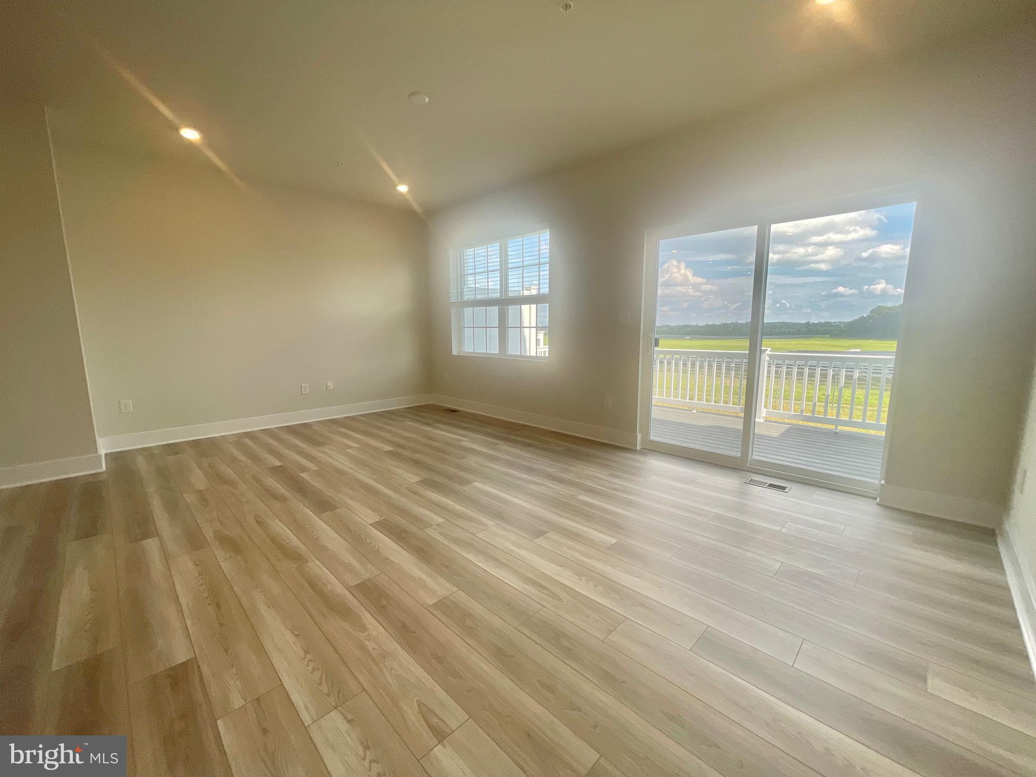 2264 Marcy Drive Frederick, MD 21702 - Photo 12 of 39 an empty room with wooden floor and windows