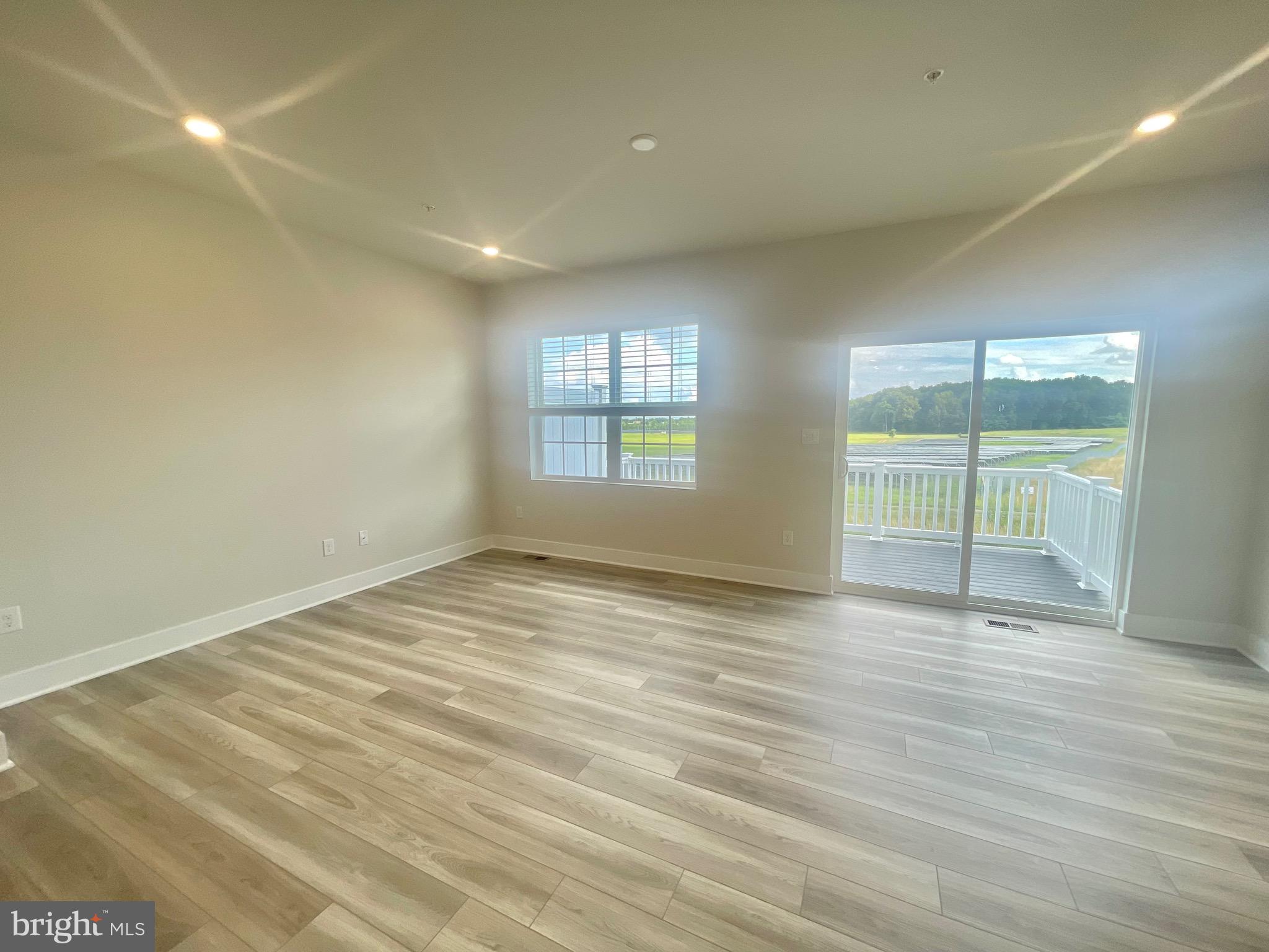 2264 Marcy Drive Frederick, MD 21702 - Photo 14 of 39 an empty room with wooden floor and windows