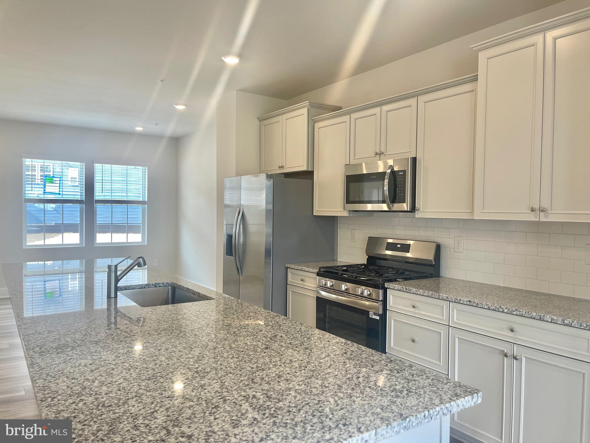 2264 Marcy Drive Frederick, MD 21702 - Photo 15 of 39 a kitchen with granite countertop a stove a sink and a refrigerator