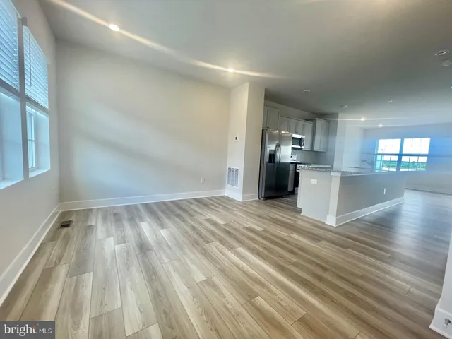 a view of a kitchen with wooden floor and a kitchen