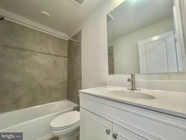 a bathroom with a sink a toilet and a bathtub
