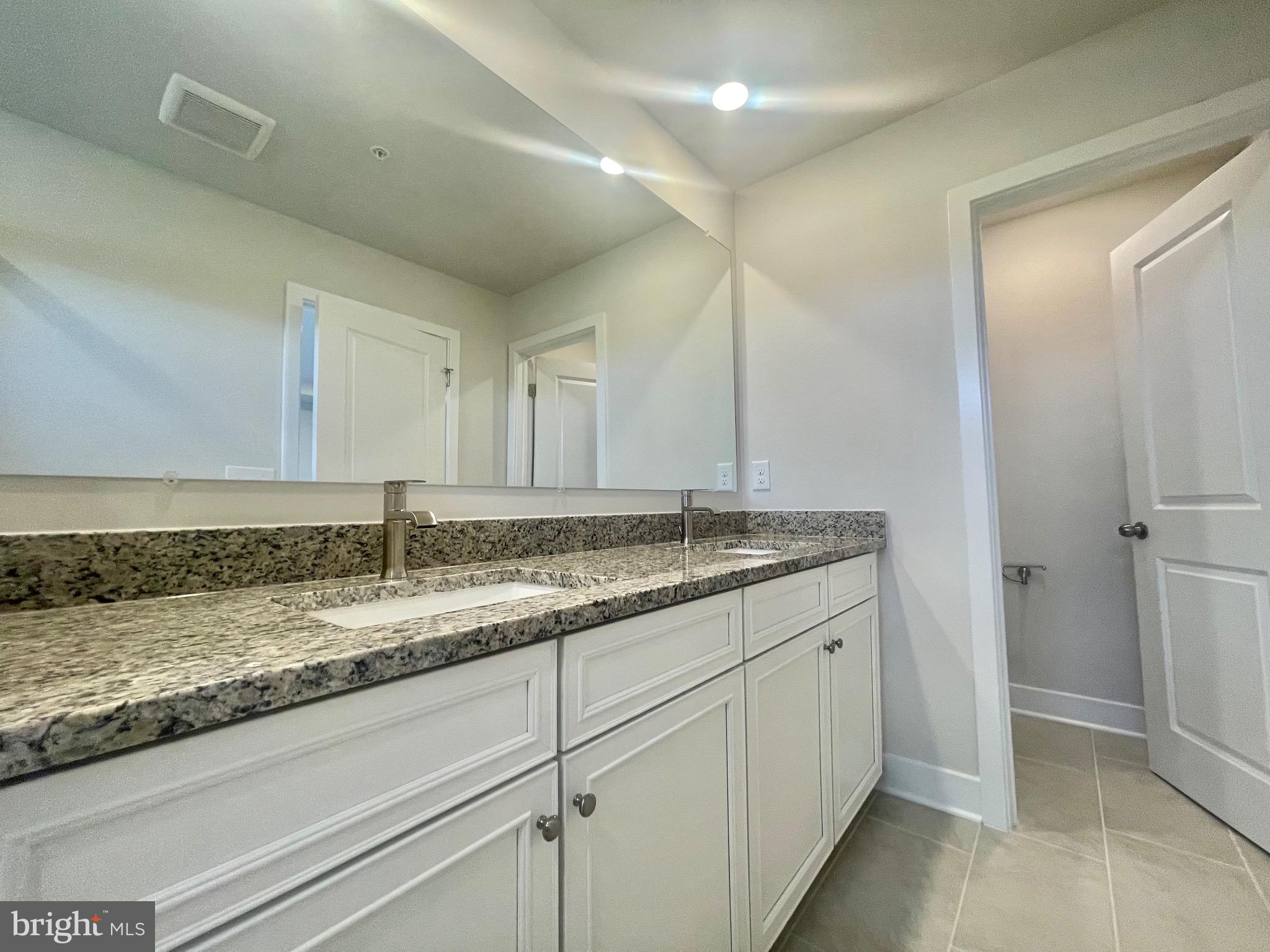 2264 Marcy Drive Frederick, MD 21702 - Photo 29 of 39 a bathroom with a granite countertop sink and a mirror