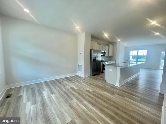 a view of a kitchen with wooden floor and a kitchen