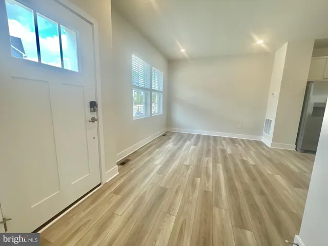 a view of wooden floor and windows in a room