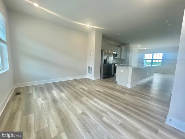 a view of a kitchen with wooden floor and a sink