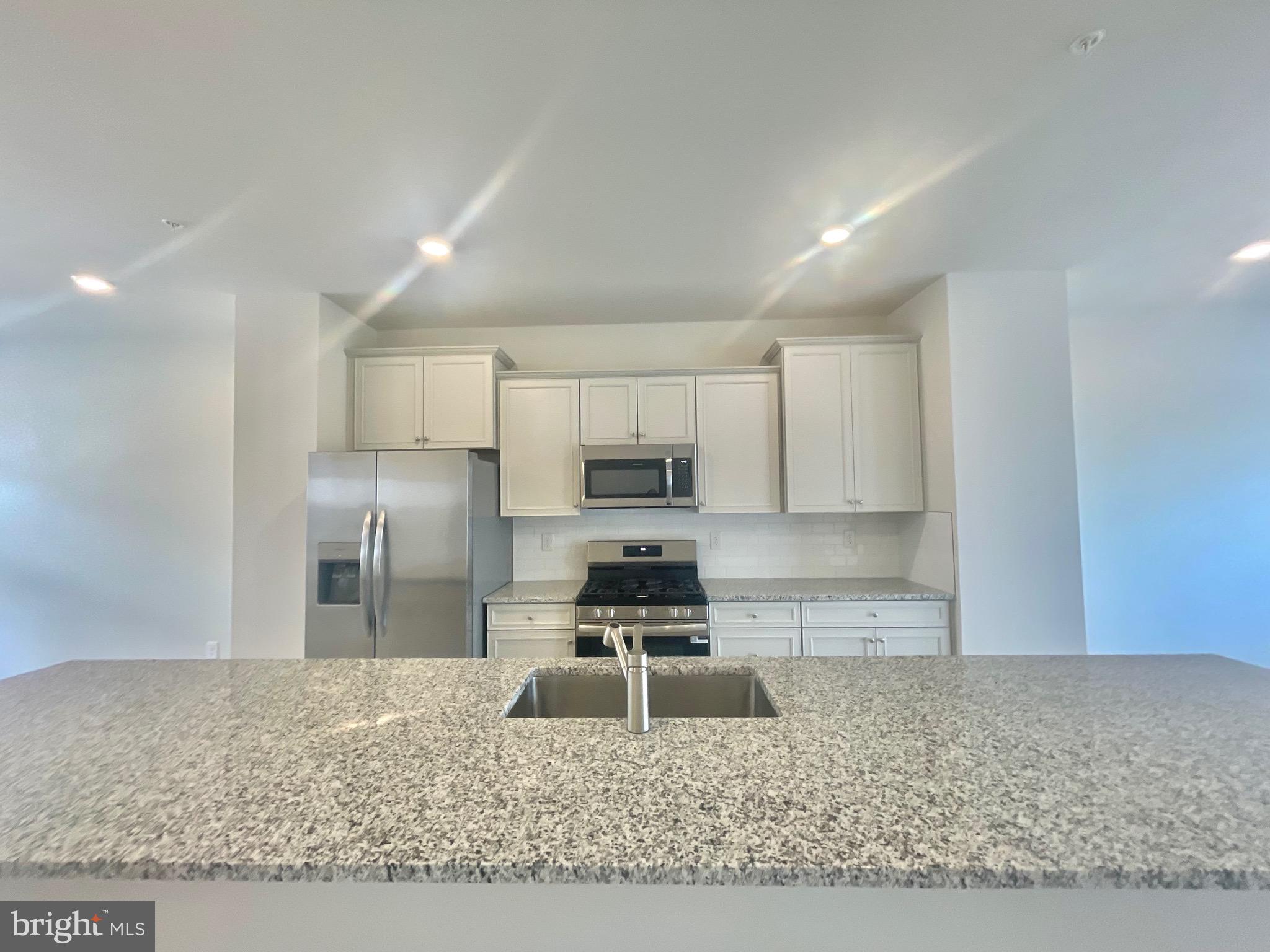2264 Marcy Drive Frederick, MD 21702 - Photo 8 of 39 a kitchen with a refrigerator sink and cabinets